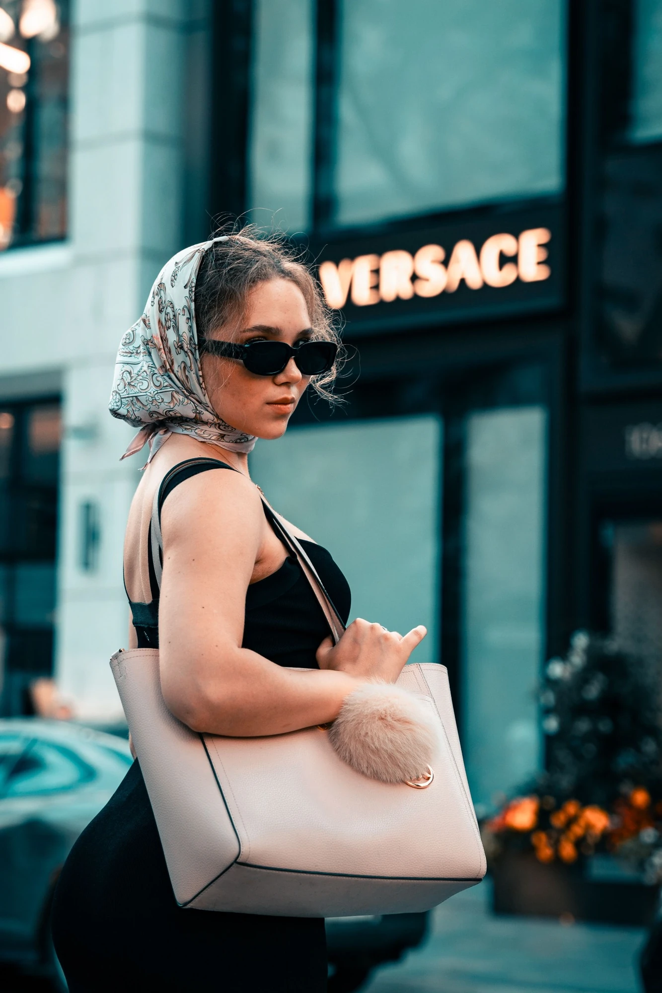 Luxury street-style fashion portrait with silk headscarf and sunglasses