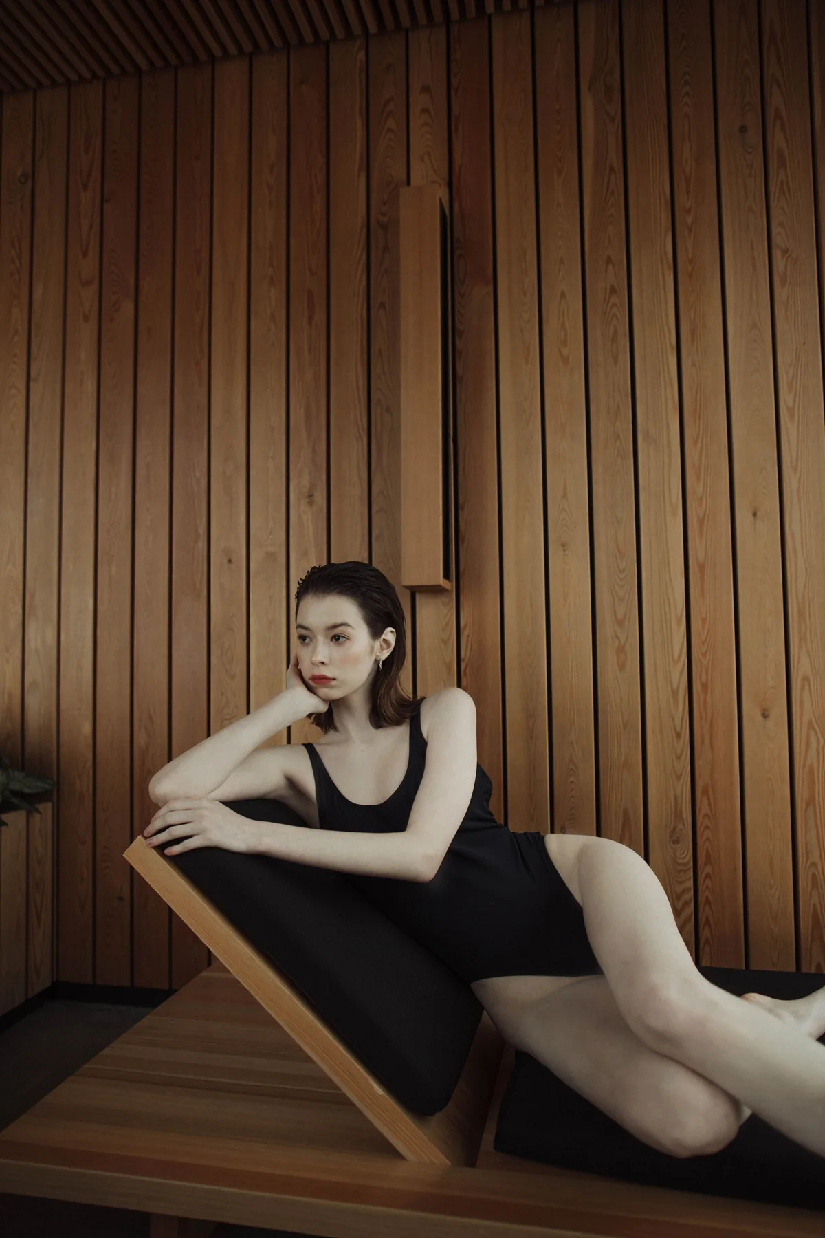 Luxury swimwear editorial portrait in a modern timber interior